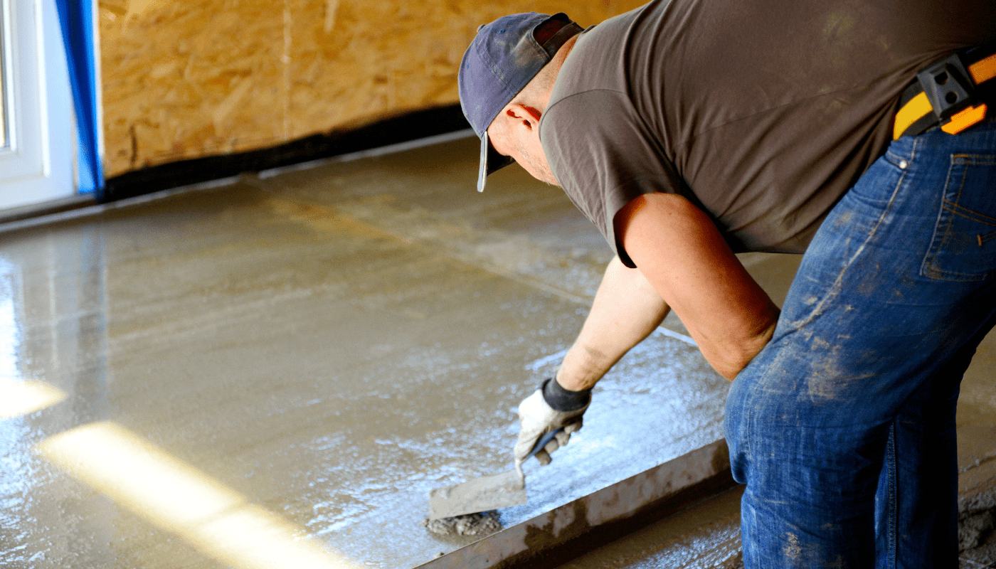 A man using a trowel to finish concrete